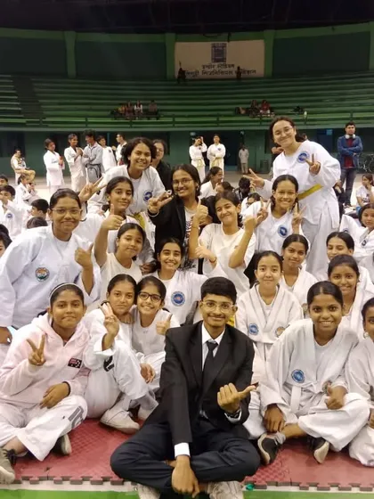 A mix of junior and senior students celebrating together after a successful competition run.