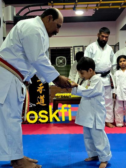 A young boy receives his new belt and medal after the colour belt test. We believe in encouraging our youngest students from their very first achievement, building their confidence for the path ahead.