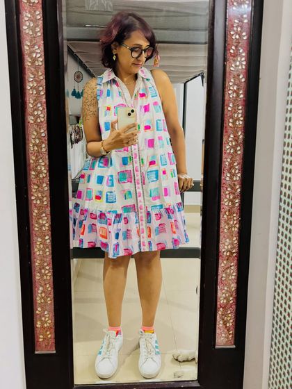A mirror selfie to capture the full look, from the vibrant dress to my comfy sneakers.