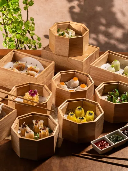 A tower of bamboo steamers filled with different types of dim sum. This shot creates a sense of excitement and variety, making you want to lift every lid.
