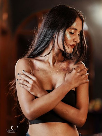 A quiet, downward glance. This portrait is about introspection, with the glitter representing the magic and complexity within.