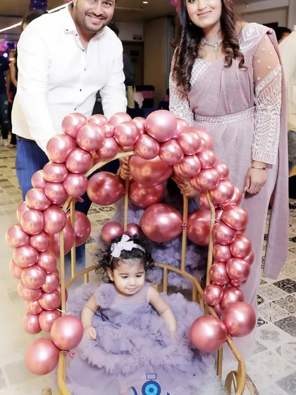 The birthday girl makes her entrance in a special chair decorated with pink balloons. Capturing these unique, planned moments is a key part of my event photography service.