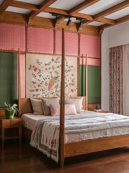 In this master bedroom, we wanted to create a sense of grandeur that felt both traditional and comforting. The headboard, a combination of silk, brocade, and a hand-painted panel, stretches to the ceiling, framed by the room's teak wood four-poster bed and exposed ceiling beams. It’s a sanctuary that feels layered and timeless, a quiet retreat from the world.