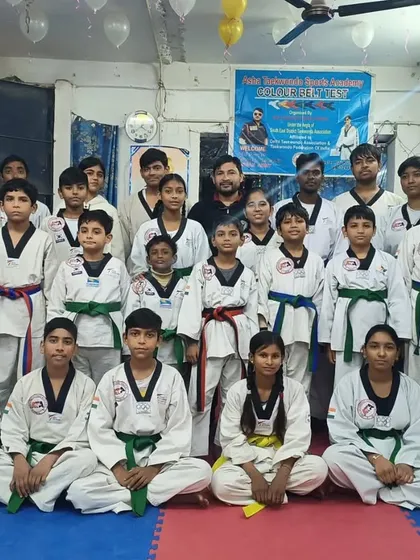 Our students after the belt ceremony inside our academy. Each new belt is a milestone in their Taekwondo journey.
