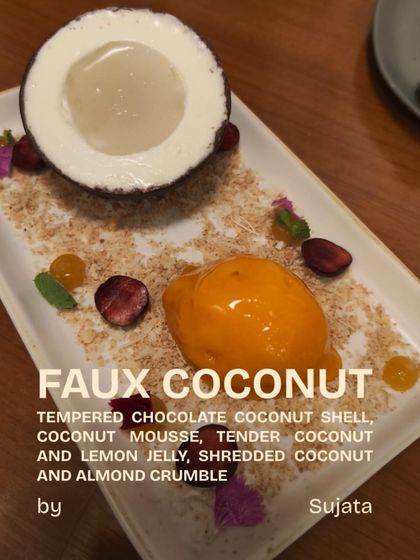 A playful creation from our Plats Playground: the Faux Coconut. This dessert features a tempered chocolate shell filled with coconut mousse and jelly, served on a bed of shredded coconut and almond crumble.