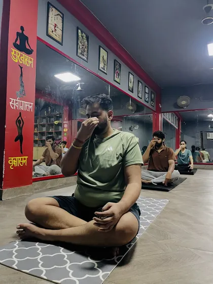 A group of students practicing pranayama together. These breathing exercises are simple to learn and can be practiced at a desk for instant stress relief.