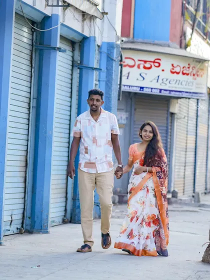 A romantic walk hand-in-hand through a classic city street, perfect for an urban-themed pre-wedding shoot.