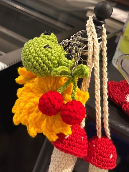 A close-up of some recent orders, including a frog keychain with cherries and a mushroom charm. I love the vibrant colors.