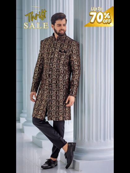 A rich, brocade-style sherwani in a deep brown and gold pattern. This pre-loved piece offers a luxurious look for less.
