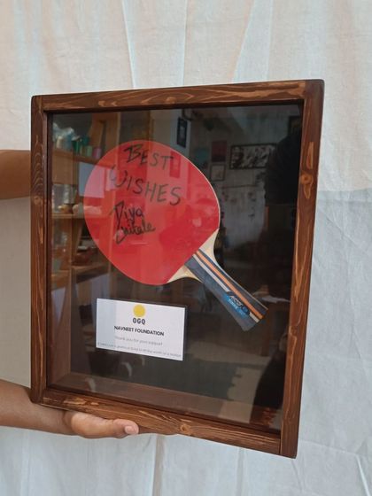 A duplicate of 110, the autographed TT paddle, securely mounted inside its custom-made wooden shadow box, ready to be presented as a thank you gift.