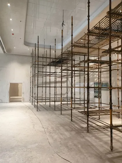 A work-in-progress shot from the Hamdard Laboratories HQ. The scaffolding structure gives a sense of the scale of the interior spaces before the final finishes are applied, revealing the skeleton of the design.