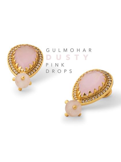 The Gulmohar Dusty Pink Drops feature a teardrop-shaped stone framed with glistening zirconia. They are a delicate and elegant option for adding a hint of color to your everyday look.