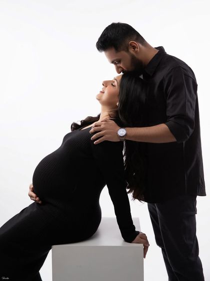 A beautiful, high-contrast portrait of a couple sharing an intimate moment. The focus is entirely on their connection.