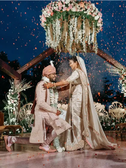 Under a sky of flowers. This breathtaking Varmala ceremony at Brahmi Resorts in Bangalore shows how we capture the scale and beauty of your perfectly planned wedding decor and rituals.