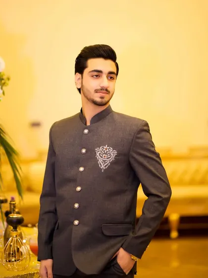 This groom's look is a perfect blend of modern style and traditional design. The fit of the jacket is impeccable.