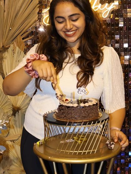 The birthday girl happily cuts her cake. Our setups provide the perfect stage for those classic birthday moments, complete with elegant cake stands and beautiful backdrops.
