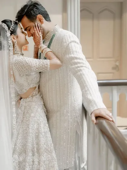 An intimate moment between the bride and groom, framed by the elegant architecture of the venue. A perfect blend of romance and style.