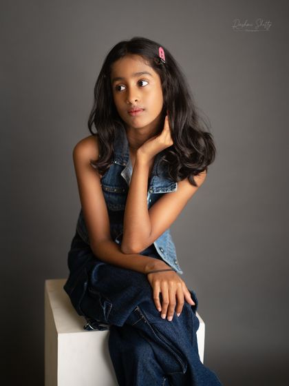A pensive and beautiful portrait. The simplicity of the black and white allows her natural beauty and expression to shine.