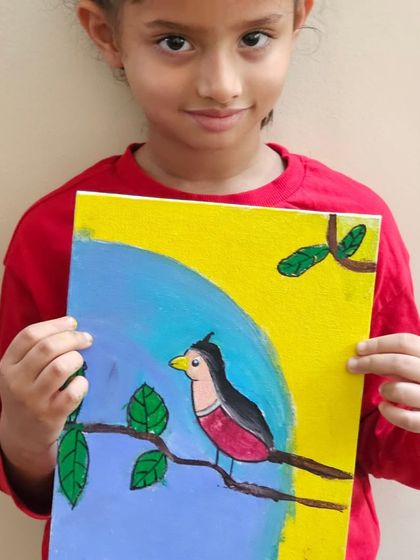 This young artist is proudly displaying her beautiful painting of a bird. Our holiday classes are a great way for kids to explore new subjects and techniques.