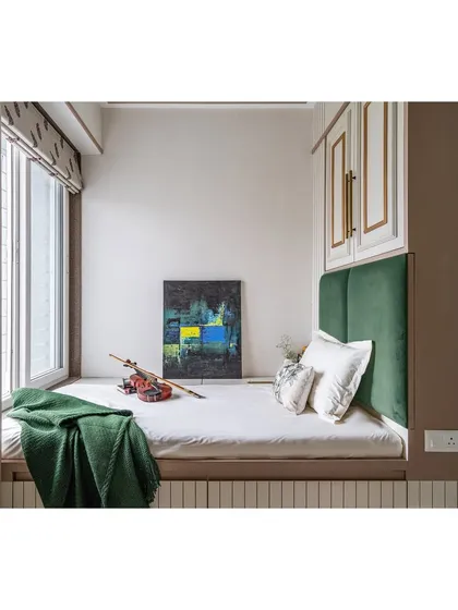 Another view of the compact guest room, showing the window-side placement of the bed to take advantage of natural light.