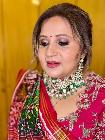Soft glam makeup for a festive occasion. I used warm, shimmering tones on the eyes and a rosy lip to complement her colorful traditional outfit and jadau jewelry.