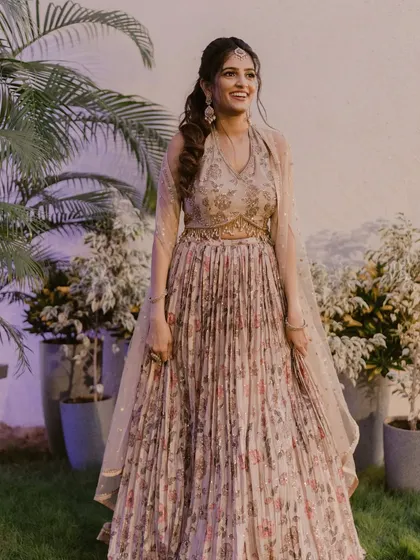 The perfect sangeet look is all about being ready to dance the night away. For this bride, we went with a floral-inspired lehenga and a fresh, glowing makeup look that was both glamorous and comfortable, ensuring she looked stunning from every angle.