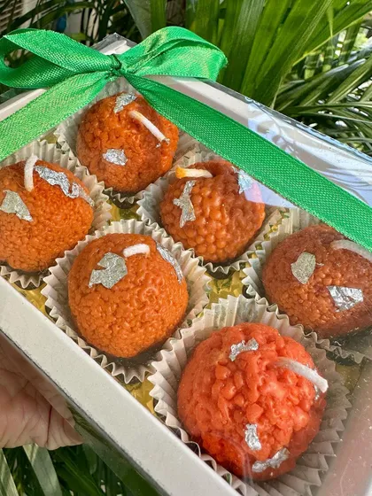 A beautifully wrapped box of six Boondi Laddoo soy candles, a classic Indian treat reimagined as a unique festive light.