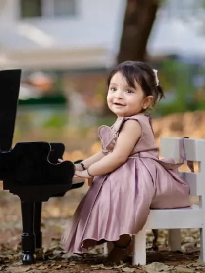 A symphony of cuteness and charm. An outdoor piano session creates a magical, storybook feel.