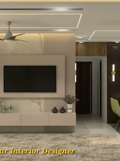 A view of the living area showcasing the TV console and a CNC-cut jali partition. These custom elements demonstrate our ability to deliver personalized interior solutions.