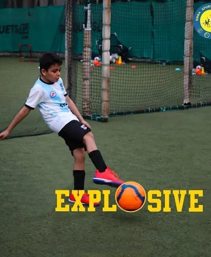 A young player unleashes an explosive kick, demonstrating the power and passion we nurture. Our turf provides a professional-quality surface for players to practice their shooting technique.
