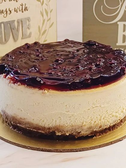 A creamy and delicious baked blueberry cheesecake with a rich blueberry compote topping.