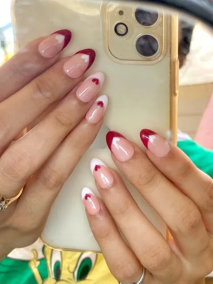 A sweet and simple way to my heart. This design features a classic French tip in both red and white, with a tiny heart detail on the accent nail for a romantic touch.