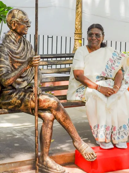 The President of India, Smt. Droupadi Murmu, seated next to a life-sized sculpture of Mahatma Gandhi at the newly inaugurated Gandhi Smriti Park. We designed the park to be a symbol of Gandhiji's enduring ideals.