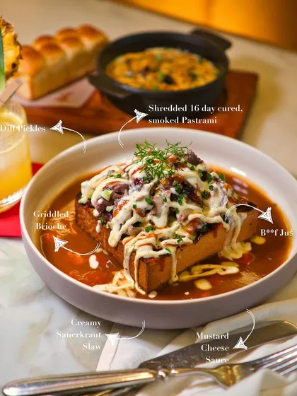 Meet the Pastrami Messy Toast, a dish that lives rent-free in our heads. We cure the pastrami for 16 days, hot smoke it, and pile it high on buttery brioche soaked in beef jus with a creamy sauerkraut slaw. It's worth getting your hands messy for.