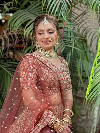 A beautiful candid shot of the bride, showcasing the soft glam makeup in natural outdoor lighting. The look is fresh, radiant, and enhances her features.