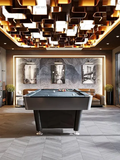 Design can also be about fun. We created this sophisticated game room as the perfect retreat, featuring a sleek pool table and a bold metallic ceiling that adds a dramatic and modern edge to the space.