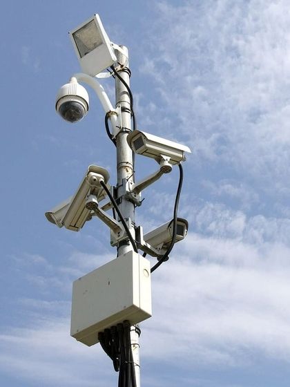 A complex multi-camera array on a single pole, designed for 360-degree surveillance of a large open area. This is an example of our custom solutions for high-security needs.