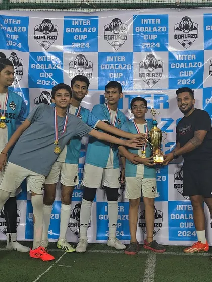Our Under-15 team posing with their coach and the trophy from the Inter Goalazo Cup.