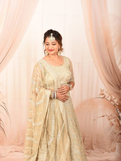 A graceful pose in a stunning lehenga. This studio shot captures the elegance and beauty of traditional Indian occasion wear.
