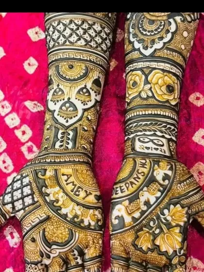This is a great example of a heavy, intricate bridal design. It includes the groom's name 'AMEY' and the bride's name 'DEEPANSHI' woven into the pattern, alongside elephants and floral motifs.
