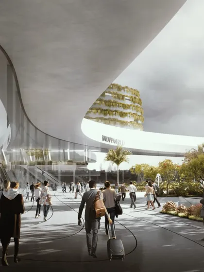 The main entrance plaza of the station, designed as a welcoming public space with lush landscaping and clear sightlines to the station building.