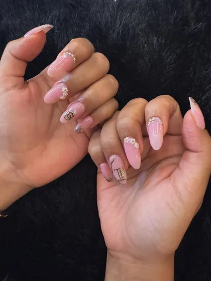 This design combines a soft pink base with designer-inspired logo art and sparkling rhinestones at the cuticle. It's a chic and trendy option for any special event.
