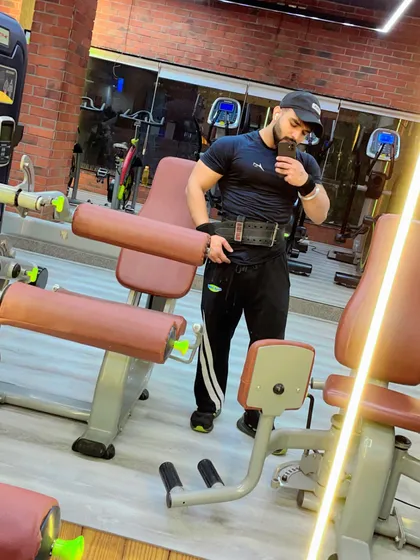 Your attention is your most valuable asset. A member gets ready for his next set, fully focused with his lifting belt on.