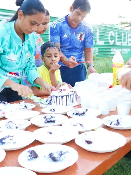 Coaches and parents help serve cake during our team birthday party. It's a community effort.