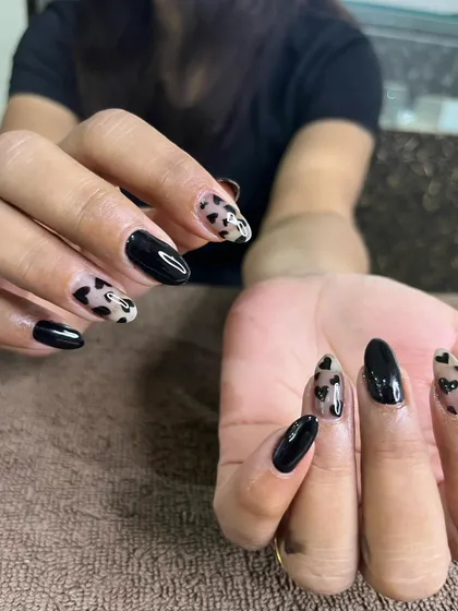 A different view of the black heart nail art, showcasing the negative space design.