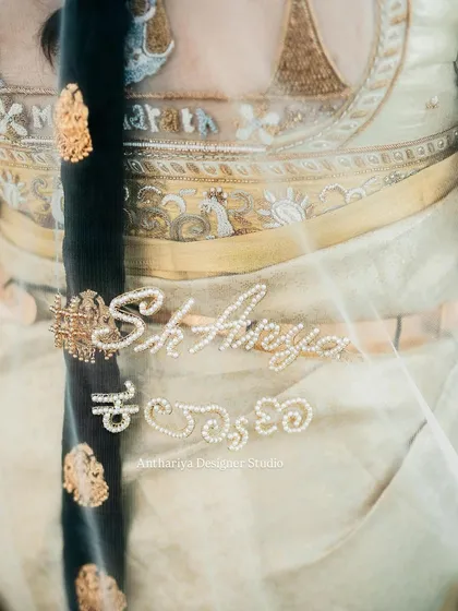It's the small touches that make an outfit truly yours. For this bride, we embroidered her wedding hashtag in both English and Kannada script onto her veil, making it a unique keepsake of her special day.