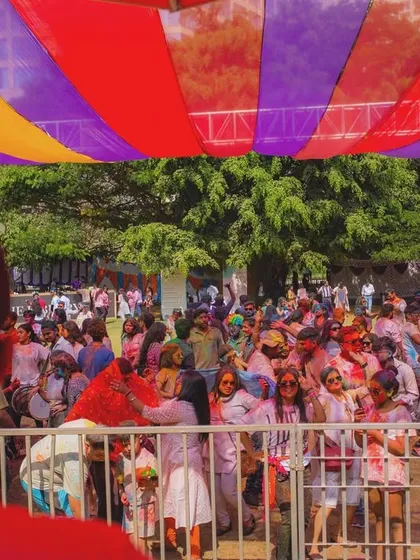 The crowd behind the barricade at our Colour Splash Holi event. We ensure professional crowd management and safety measures even at our most high-energy parties.