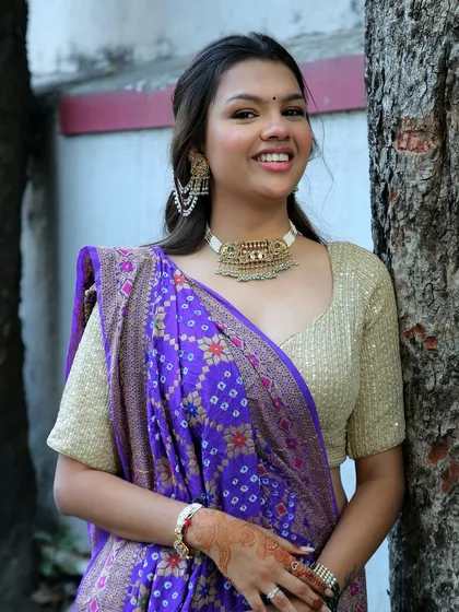 A close-up of my own Kankotri look. I chose a gold choker and a shimmery blouse to go with my purple saree, keeping the makeup fresh and glowy.