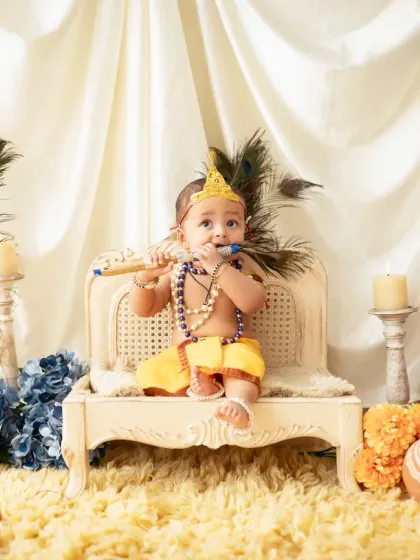 A sweet baby dressed as Lord Krishna, playing a flute. These themed shoots are a wonderful way to celebrate cultural traditions and create lasting memories.