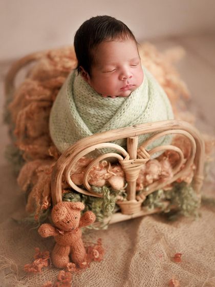 Tiny miracle and endless joy. The combination of soft mint green and earthy brown textures creates a beautiful, calming color palette for this portrait.